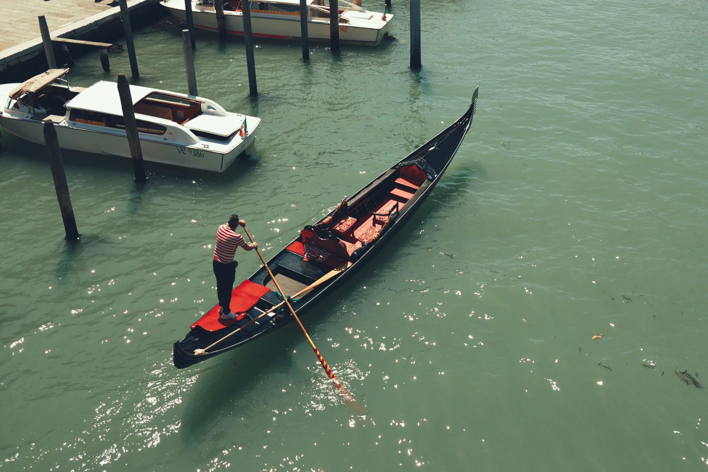 a person stands on a boat in the water