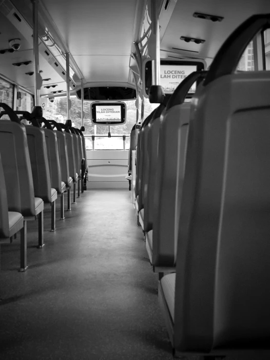 the inside of a bus with seats for passengers