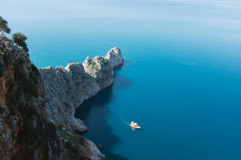 a small boat is in the blue water