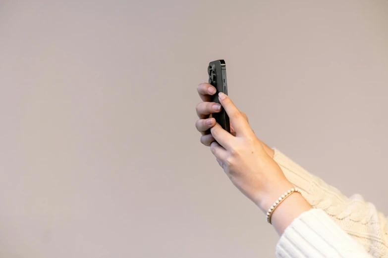 a close up of a person holding a cell phone