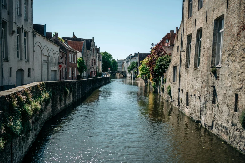 a small river running between old buildings in the city