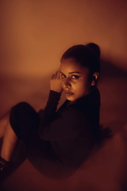 a woman leaning on the wall while looking at the camera