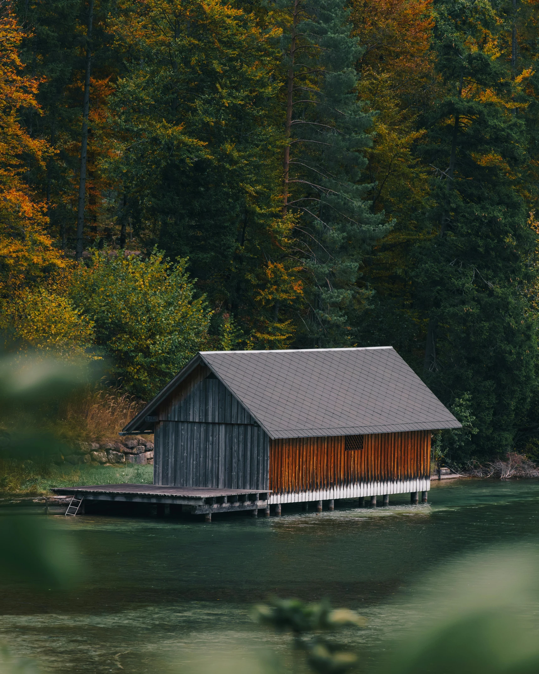 a boat dock with a boat house floating on top of it