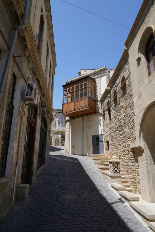 a small street in the middle of old european stone houses