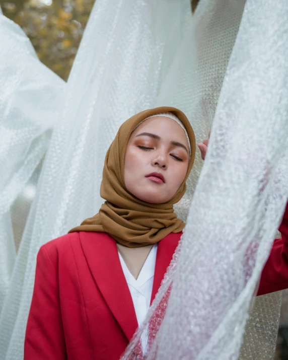 a woman in a scarf standing next to a string