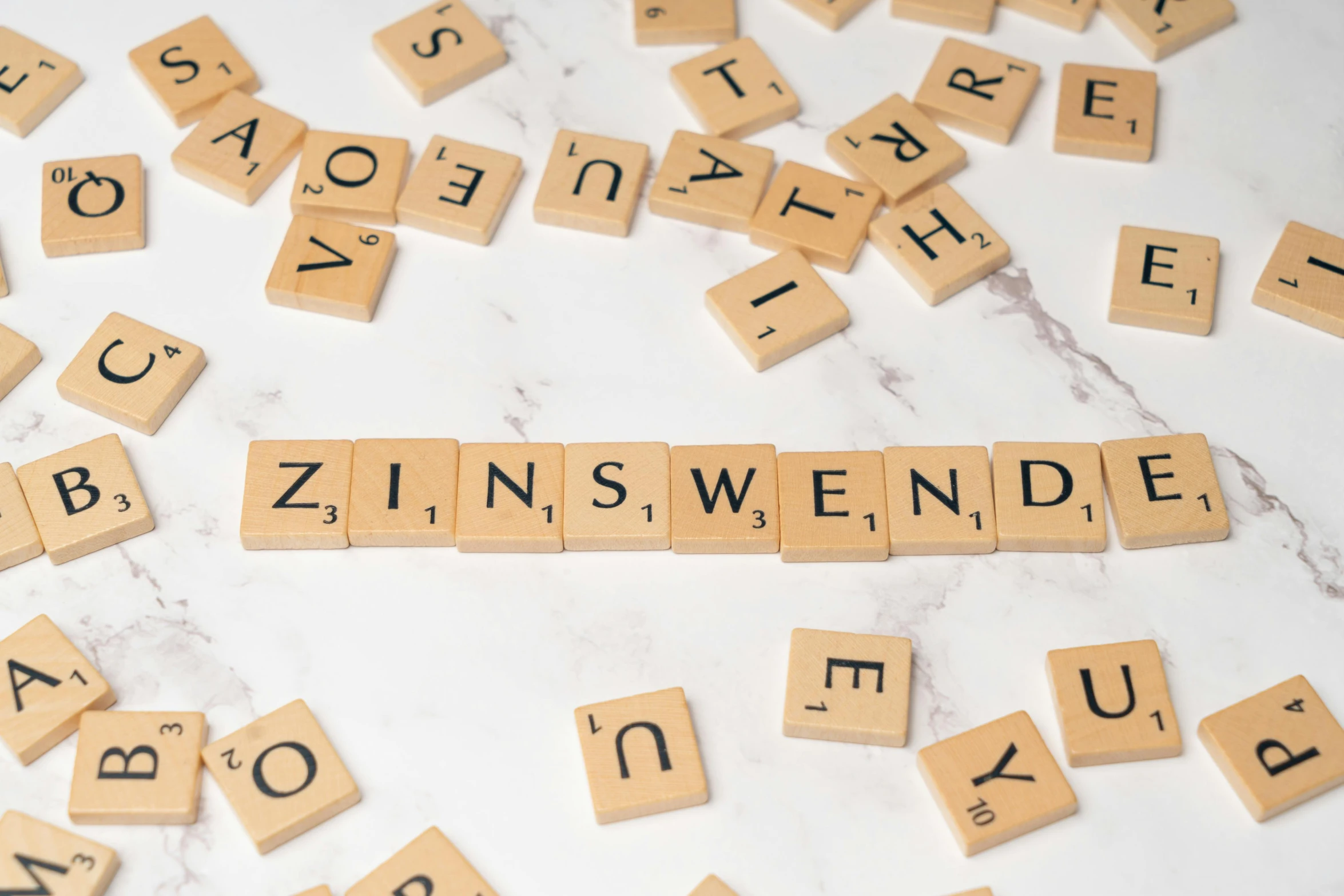 several scrabble tiles spelling words that spell out the word swense