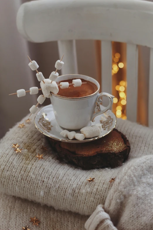 a white cup sitting on top of a wooden log