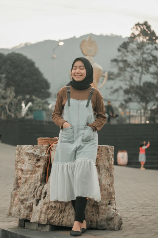 a woman standing on a piece of wood