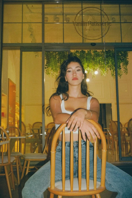 a young woman sitting on a chair next to a building