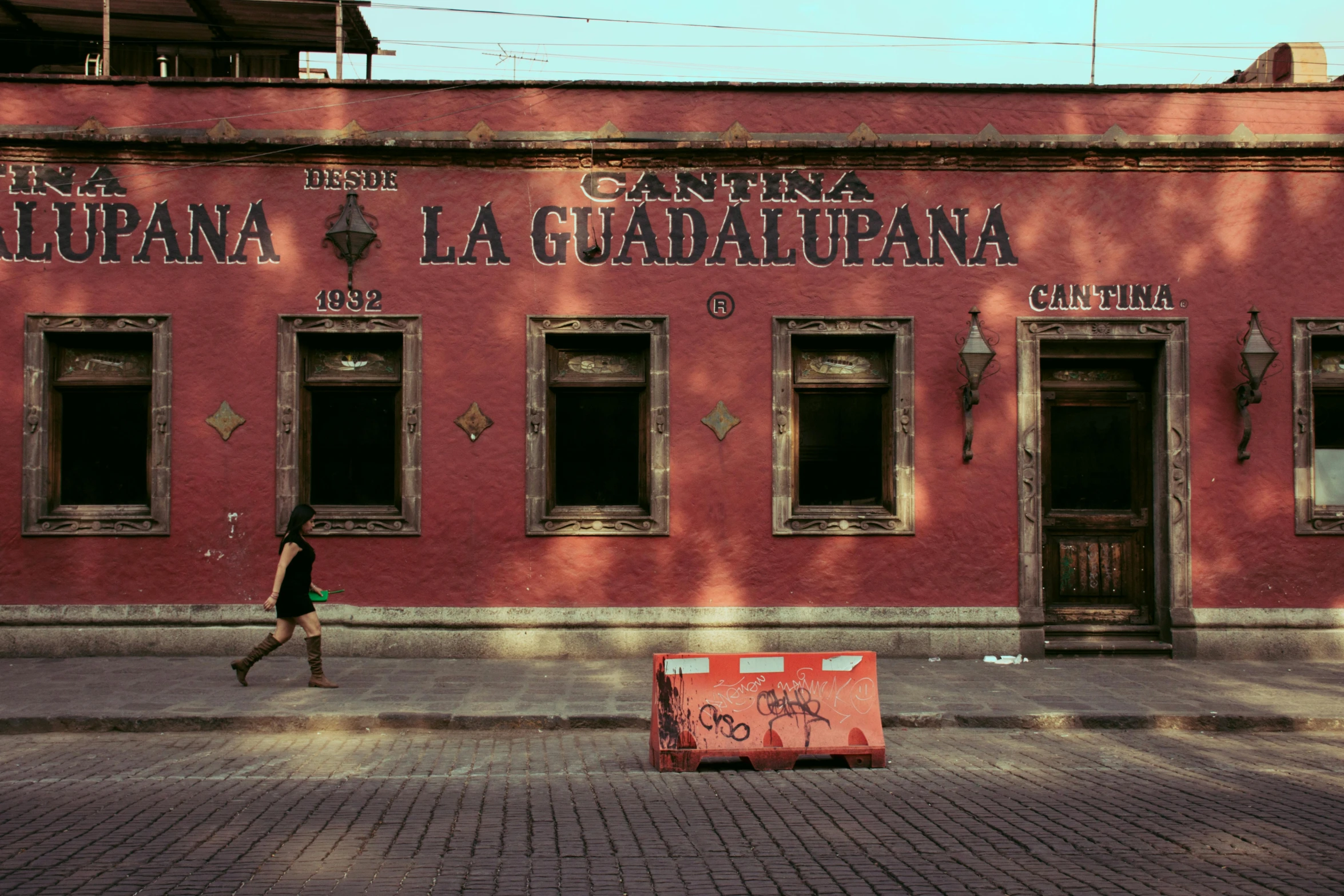 a red building with people walking in front