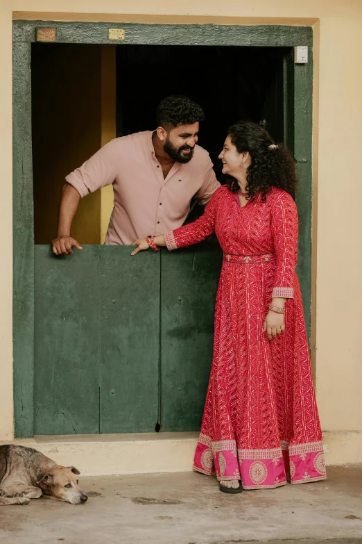 the couple stand by the window looking at each other