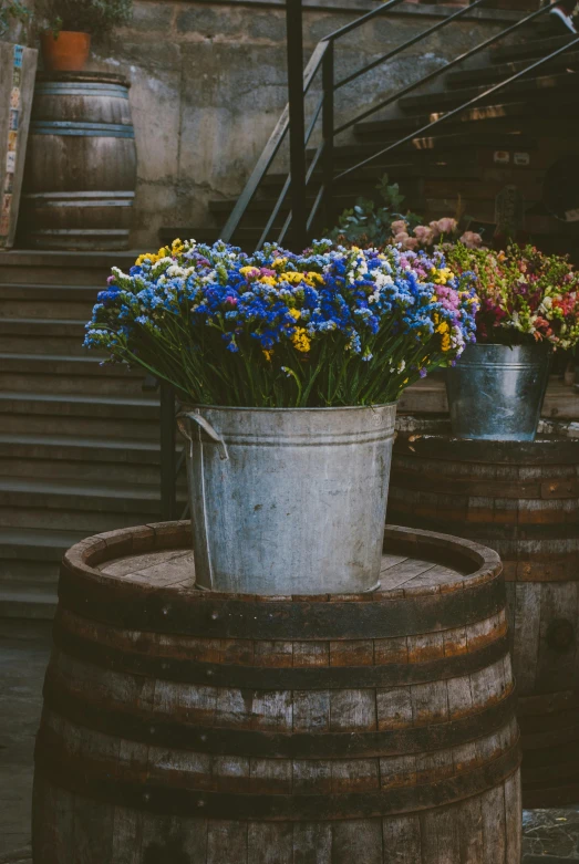 a bucket filled with purple and blue flowers