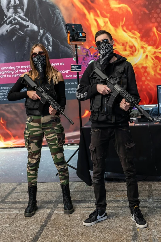 two men dressed in army clothing are holding guns