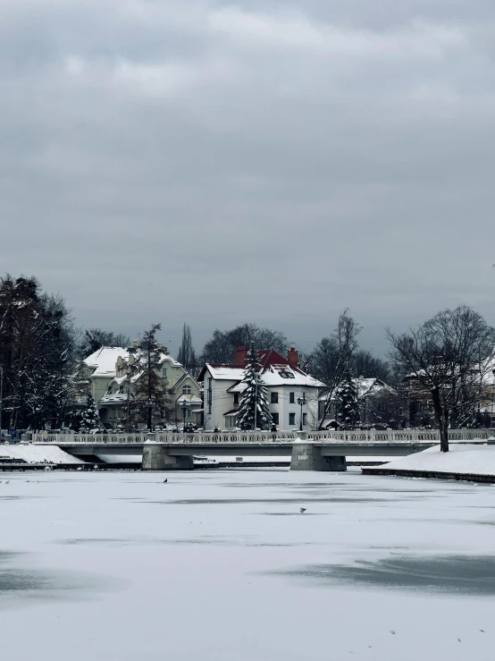 the white houses is lined up along a snowy river