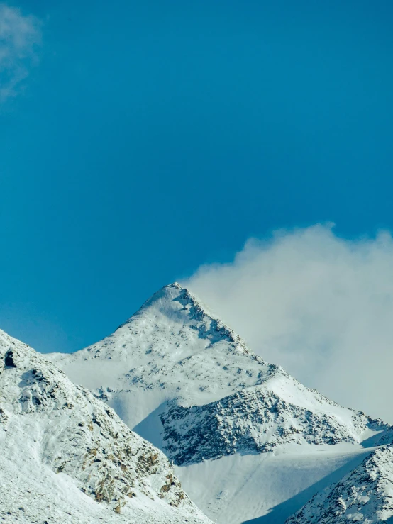 a snowboarder is jumping over a small hill