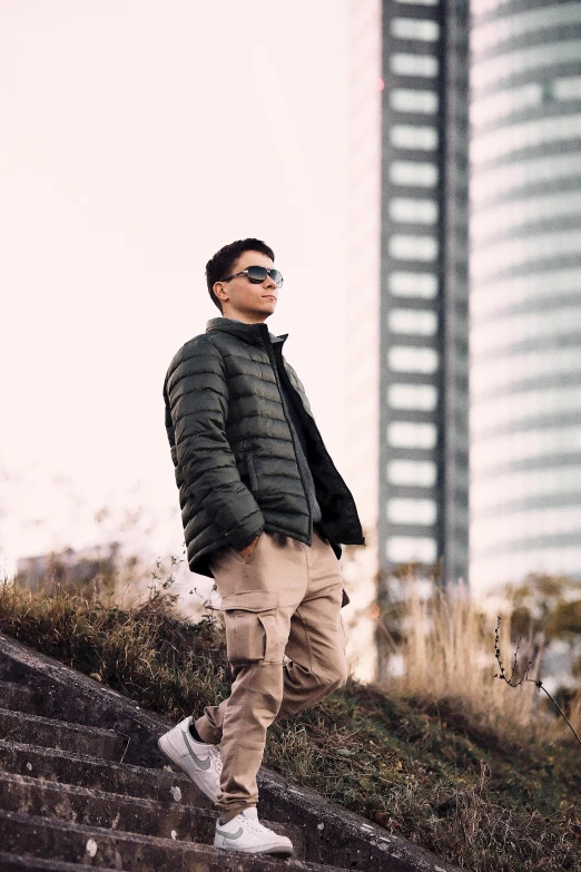 a man with sunglasses walking down a road