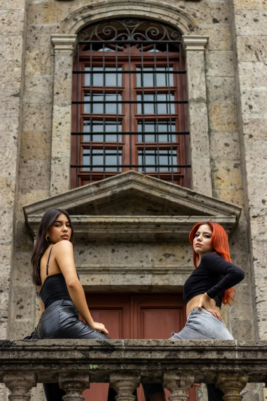 two woman wearing black shirts, standing next to each other