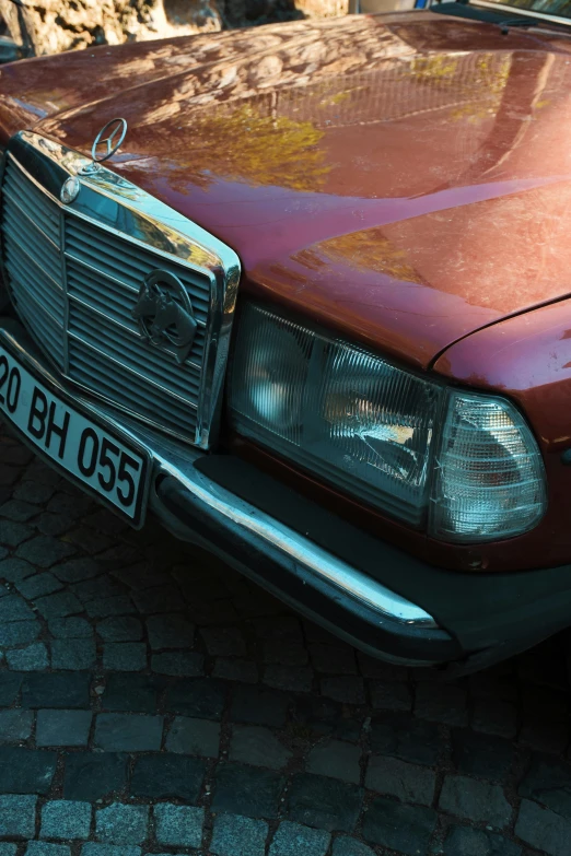 a mercedes benz with rust on the hood