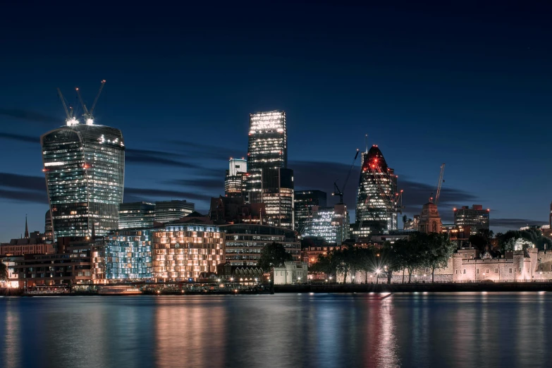 city skyline at night lit up by brightly colored lights