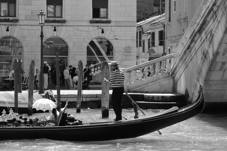 a gondola filled with people in the middle of a canal