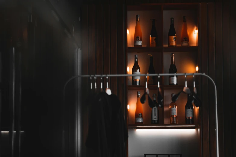 a black cabinet with bottles and glasses behind it