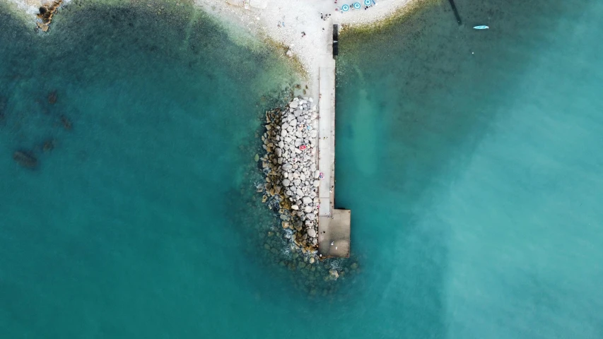an aerial po of a pier that is near the ocean