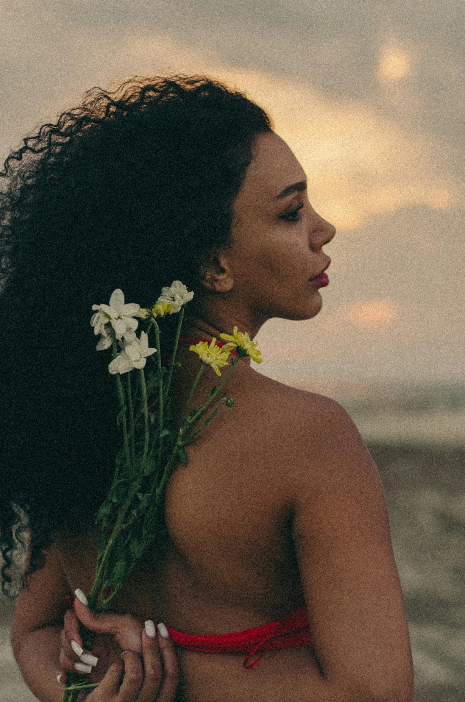 a woman with flowers in her hair is holding onto another woman's shoulder