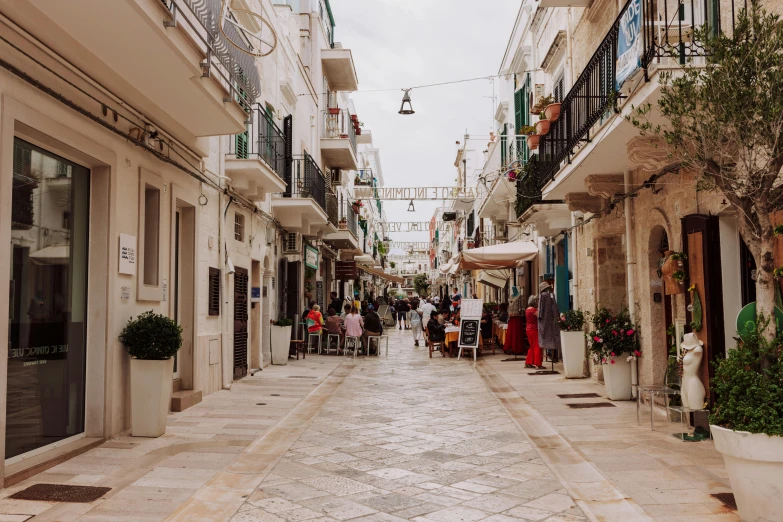 people walking down an alley near various buildings