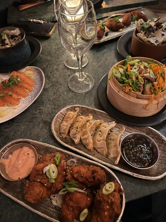 many dishes of food sit on a table