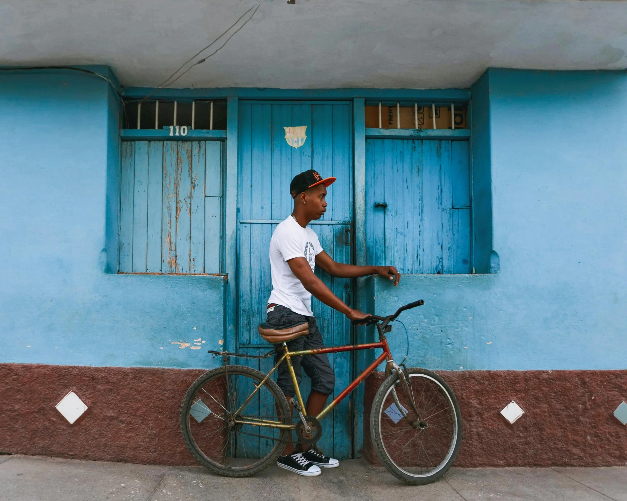 a person standing next to a bicycle on the sidewalk