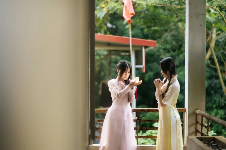 two woman standing on the steps are praying