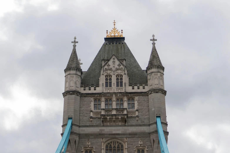 a tower with a very large clock and three steeples