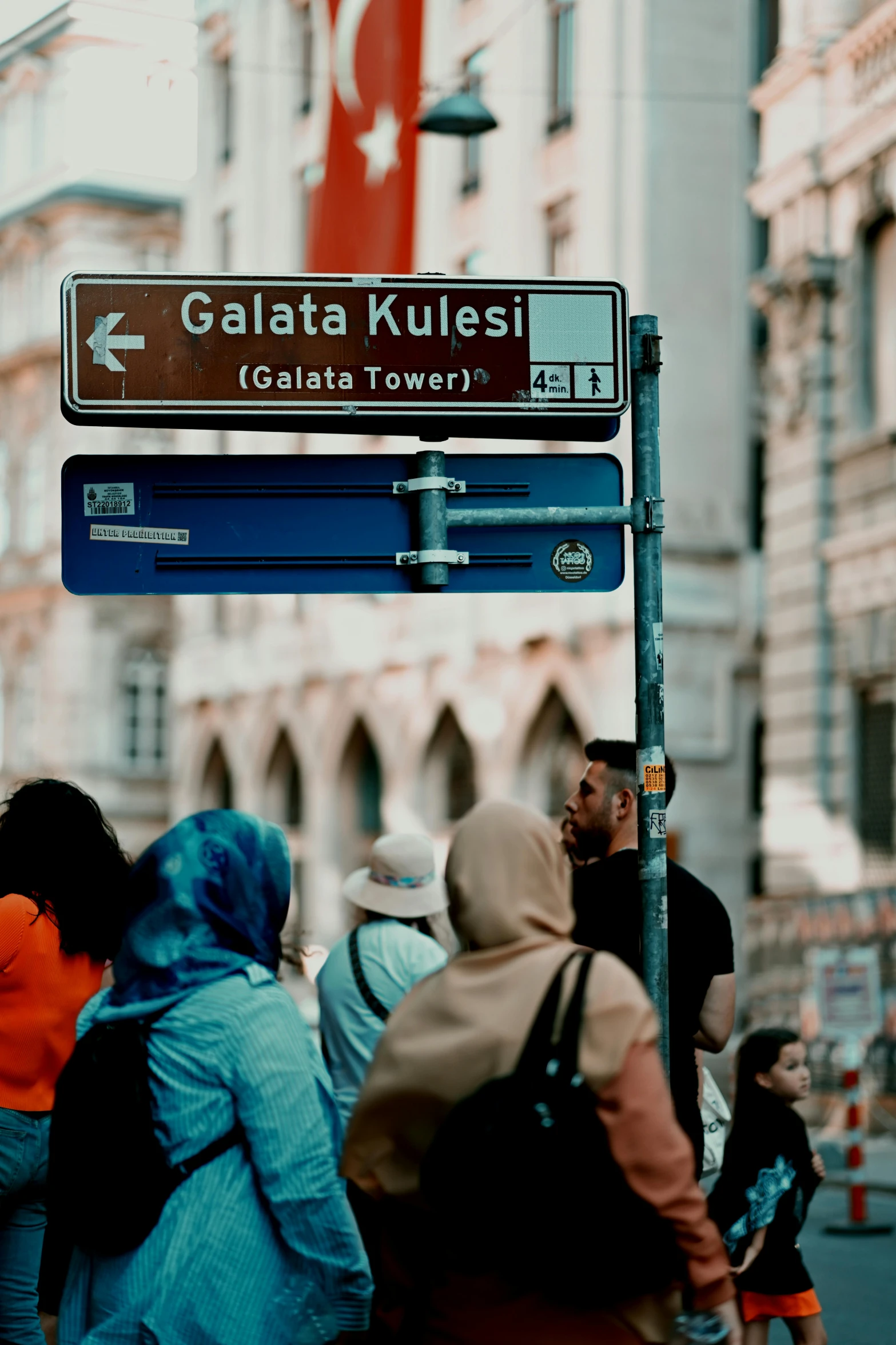 pedestrians at the corner of galata kuresi in a foreign country