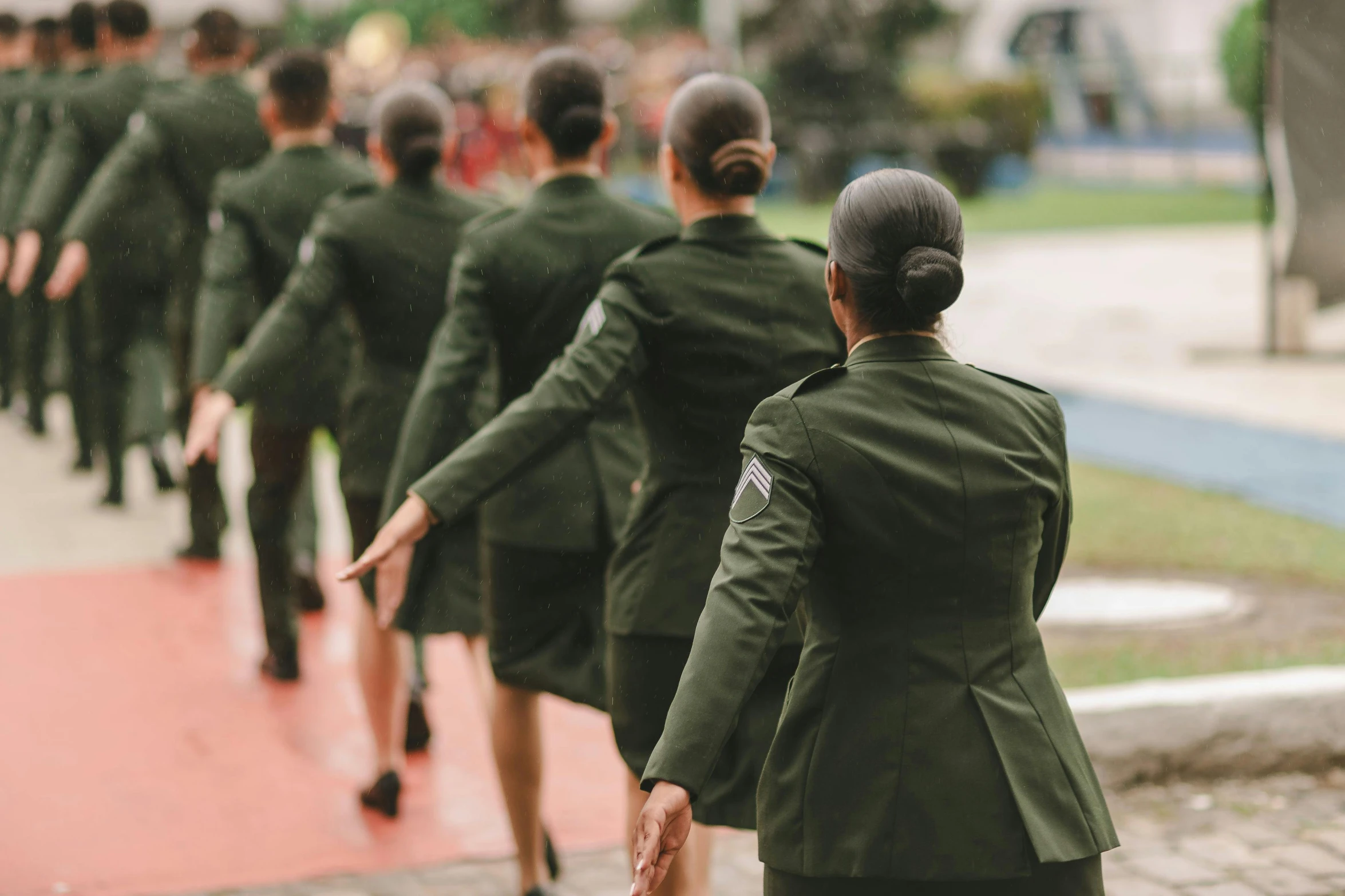 several military women walking down a road together