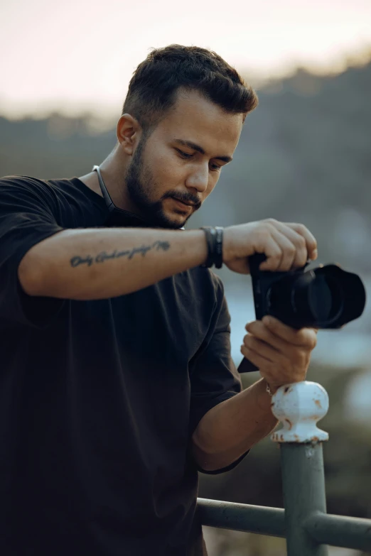 a man with a camera takes pictures from his balcony