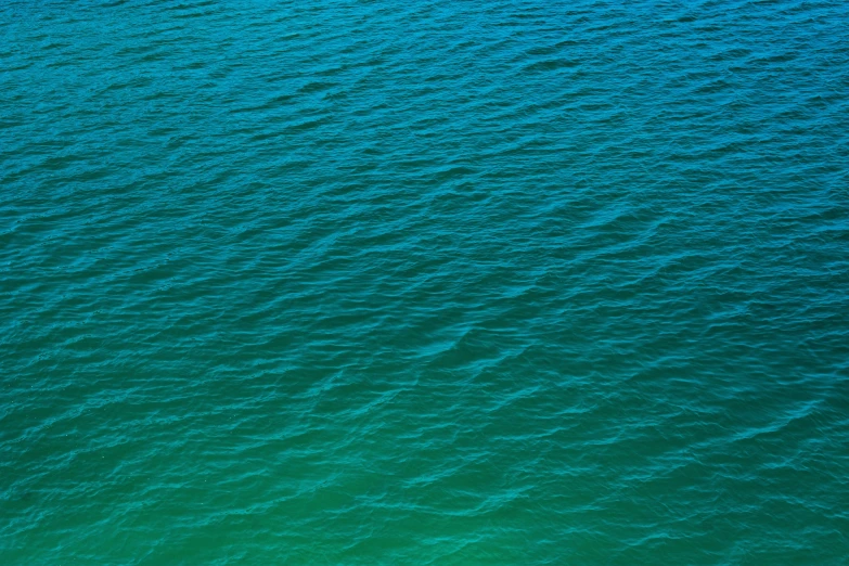 a sail boat floating on top of a body of water