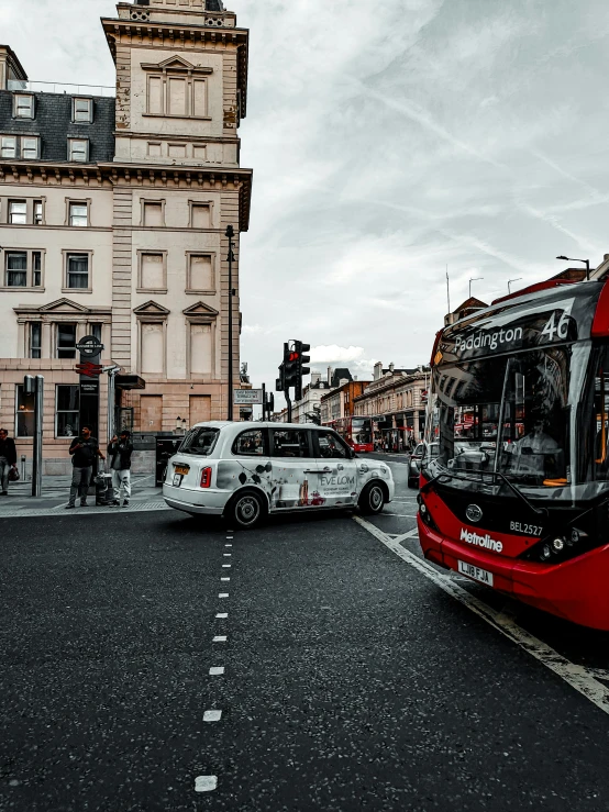 two cars are parked near the bus on the street