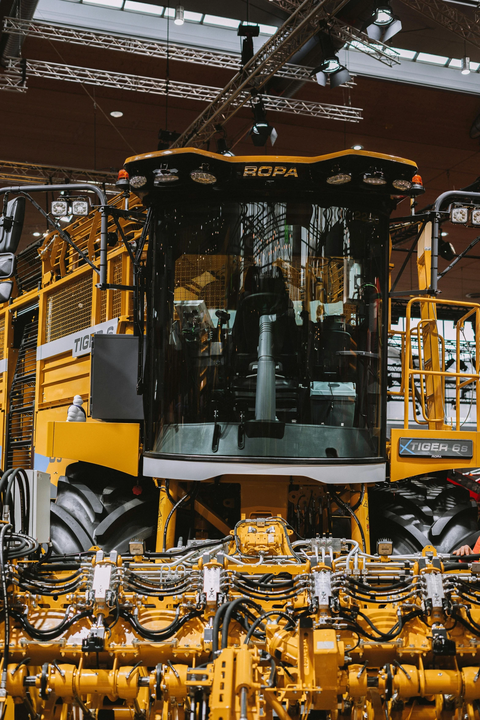 large yellow machinery inside a building under some lights