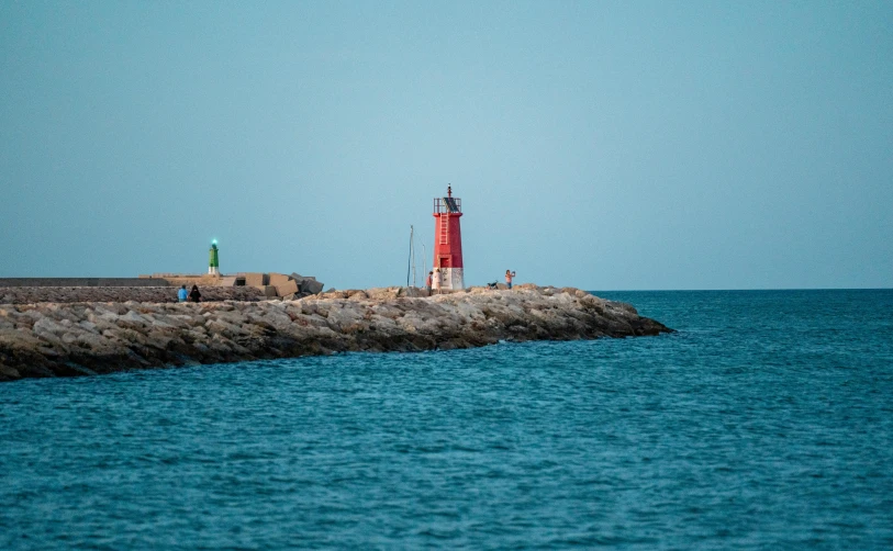 a lighthouse on top of a rock in the water