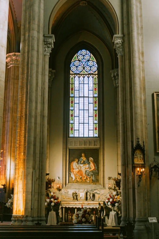 there is an altar with statues and candles in the church