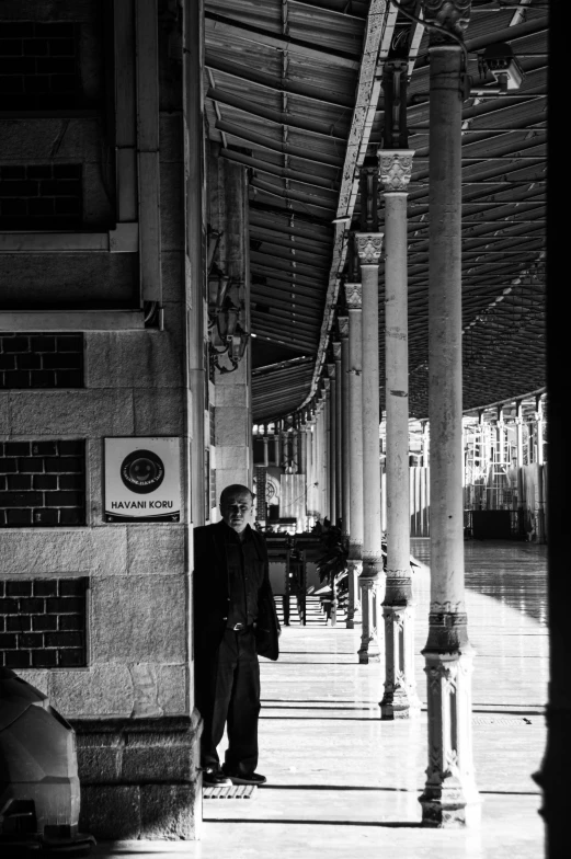 a black and white po of a man standing in a courtyard