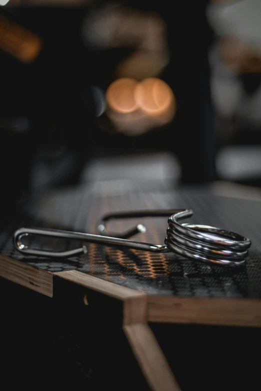 a pair of scissors sitting on top of a wooden board