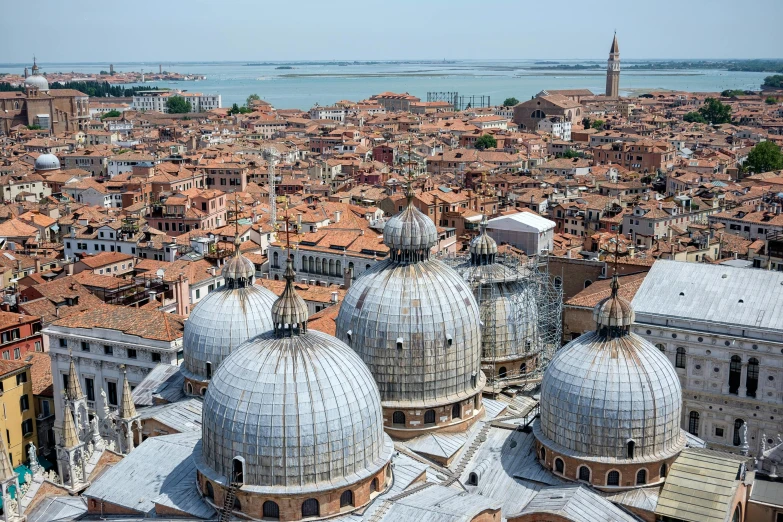 the rooftops of several buildings near a body of water