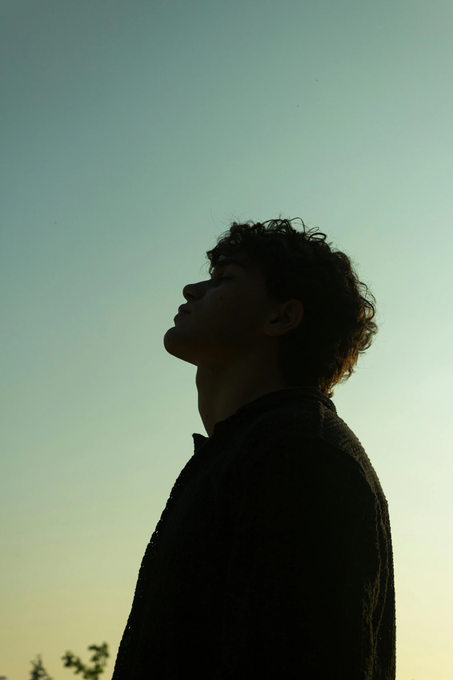 an open area with a person standing and looking up at the sky