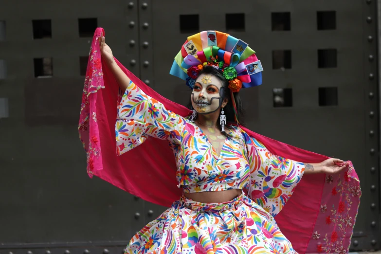 a woman in colorful makeup and headdress poses for a po