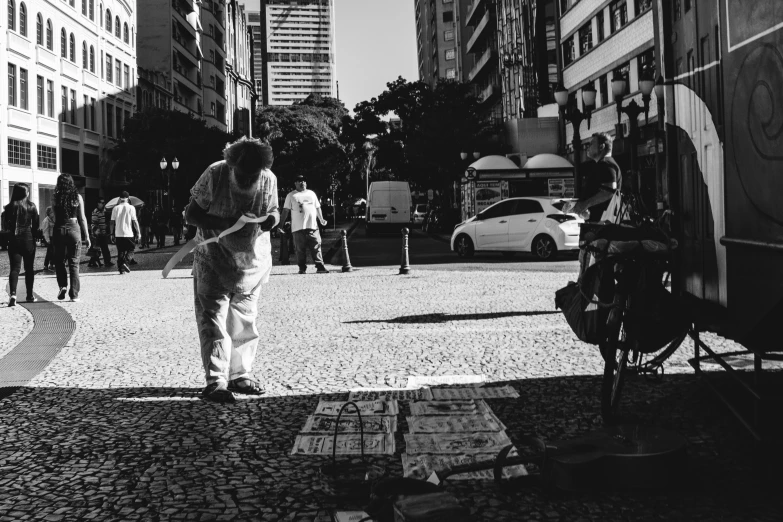 black and white image of a man walking down a street