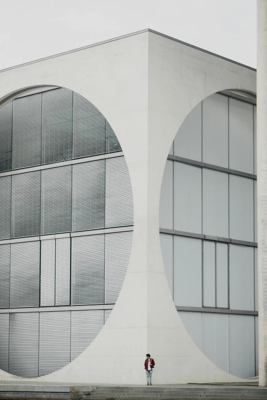 a couple of people walking in front of a building