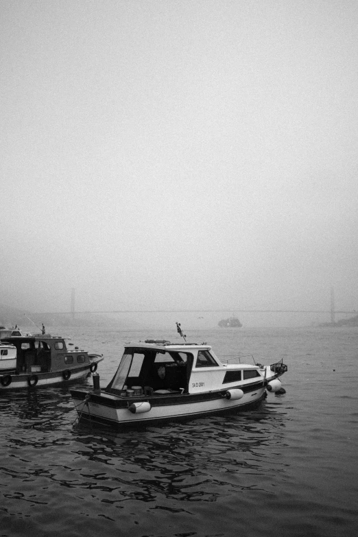 two boats in the water near a shore