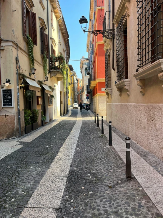 a small cobblestone street with bricked buildings