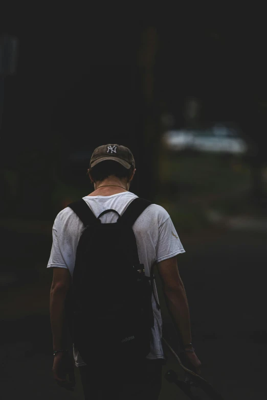 a person walking with a backpack and a tennis racket